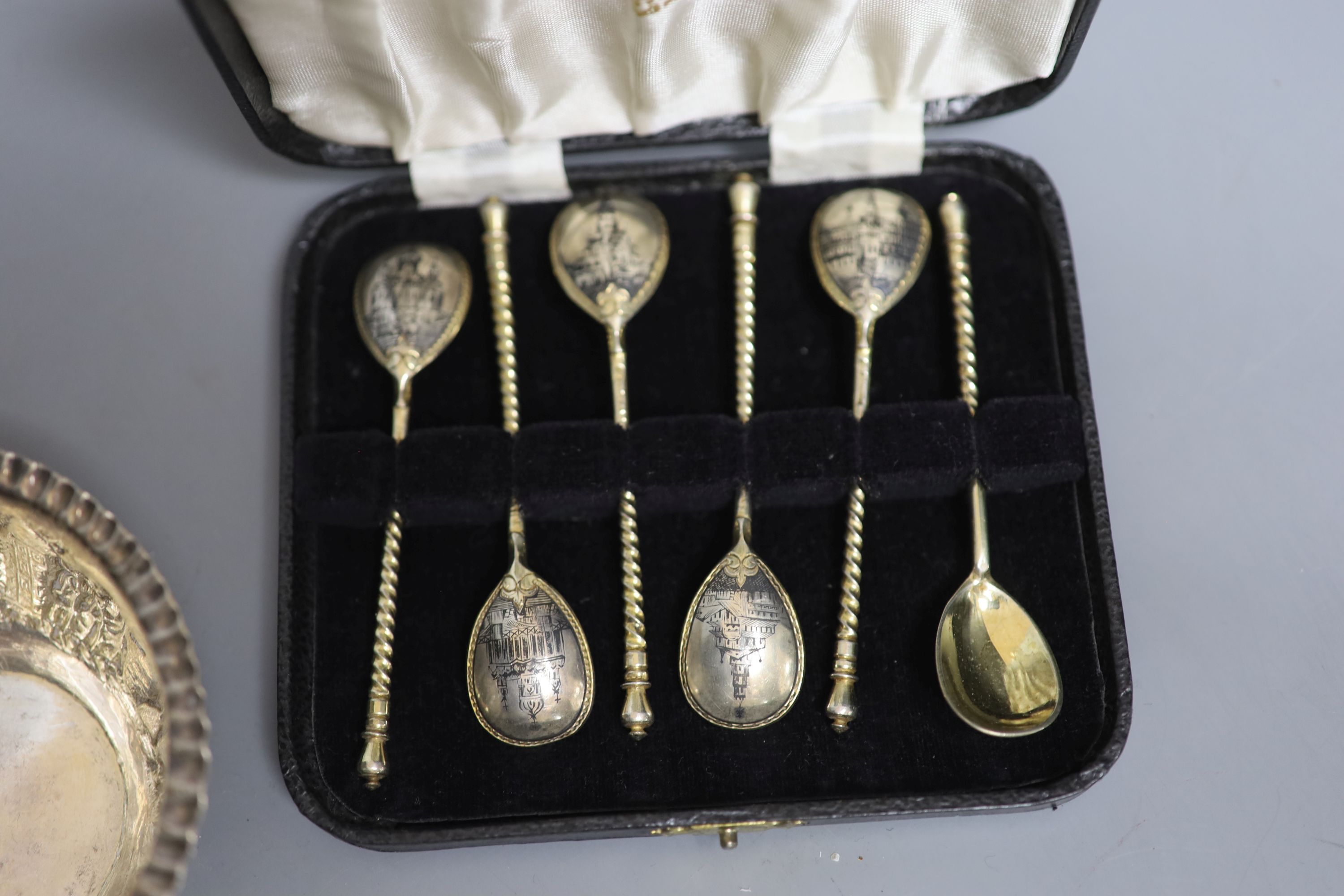 A cased set of six late 19th century Russian 84 zolotnik and niello teaspoons, three sterling kiddush cups, a French white metal napkin ring, a small sterling napkin ring and an Indian white metal bowl.